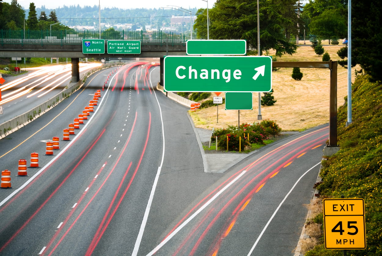 View of a freeway from an overpass at dusk; the word "Change" added in place of an exit name.